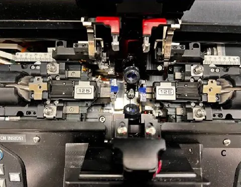 Inside the CO2 laser splicer: two fiber holders marked 125 aligned around the fiber